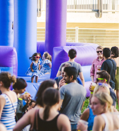 crowd of people around a bouncy castle