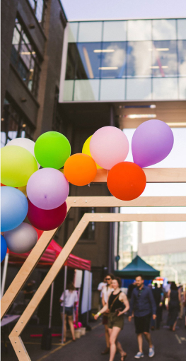 hexagonal wooden installation with colourful balloons