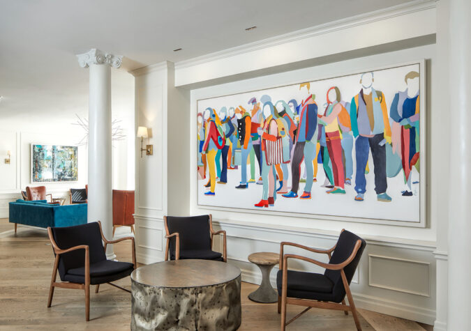 lounge area with bright painting of a crowd of people