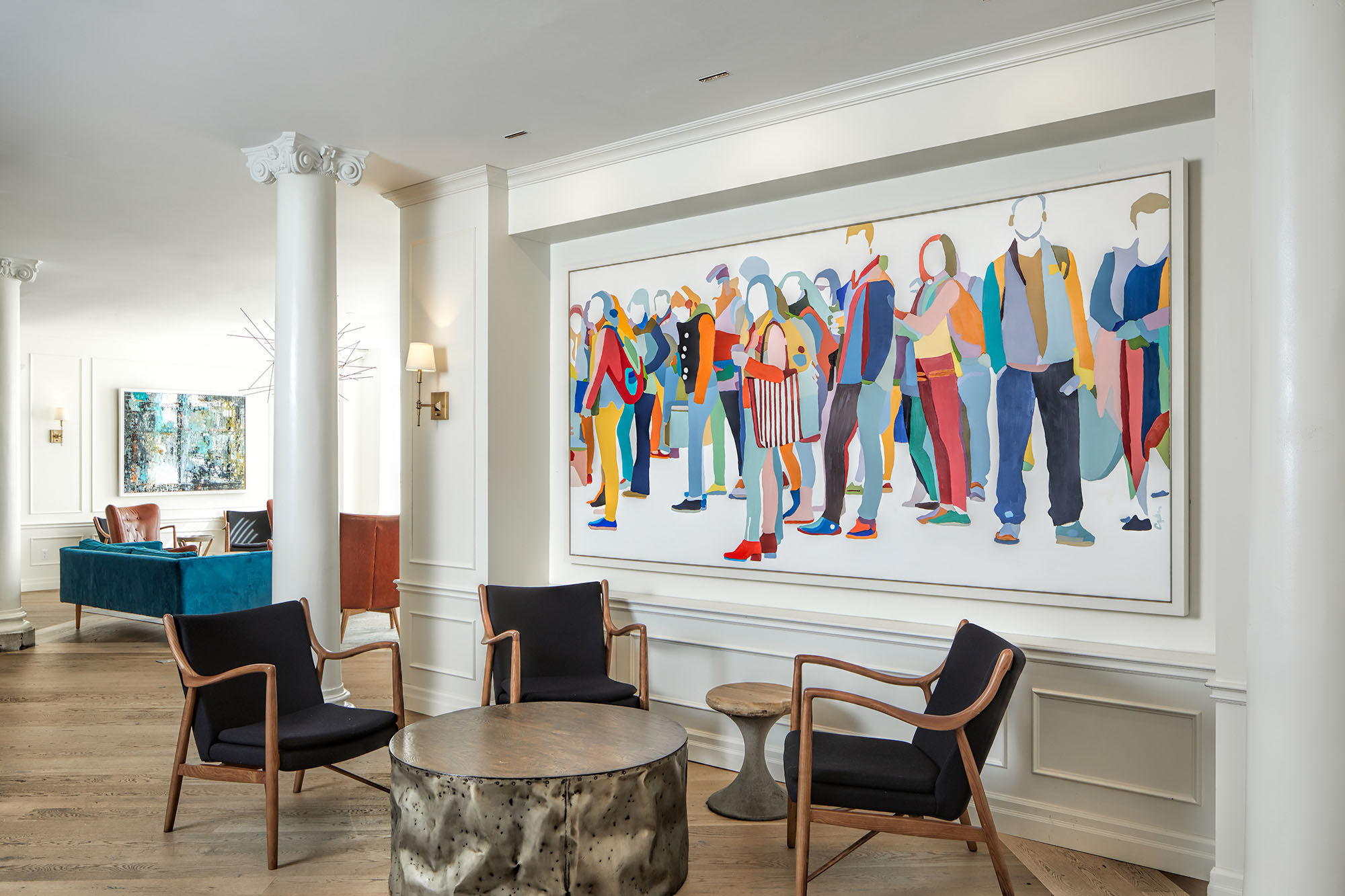 lounge area with bright painting of a crowd of people