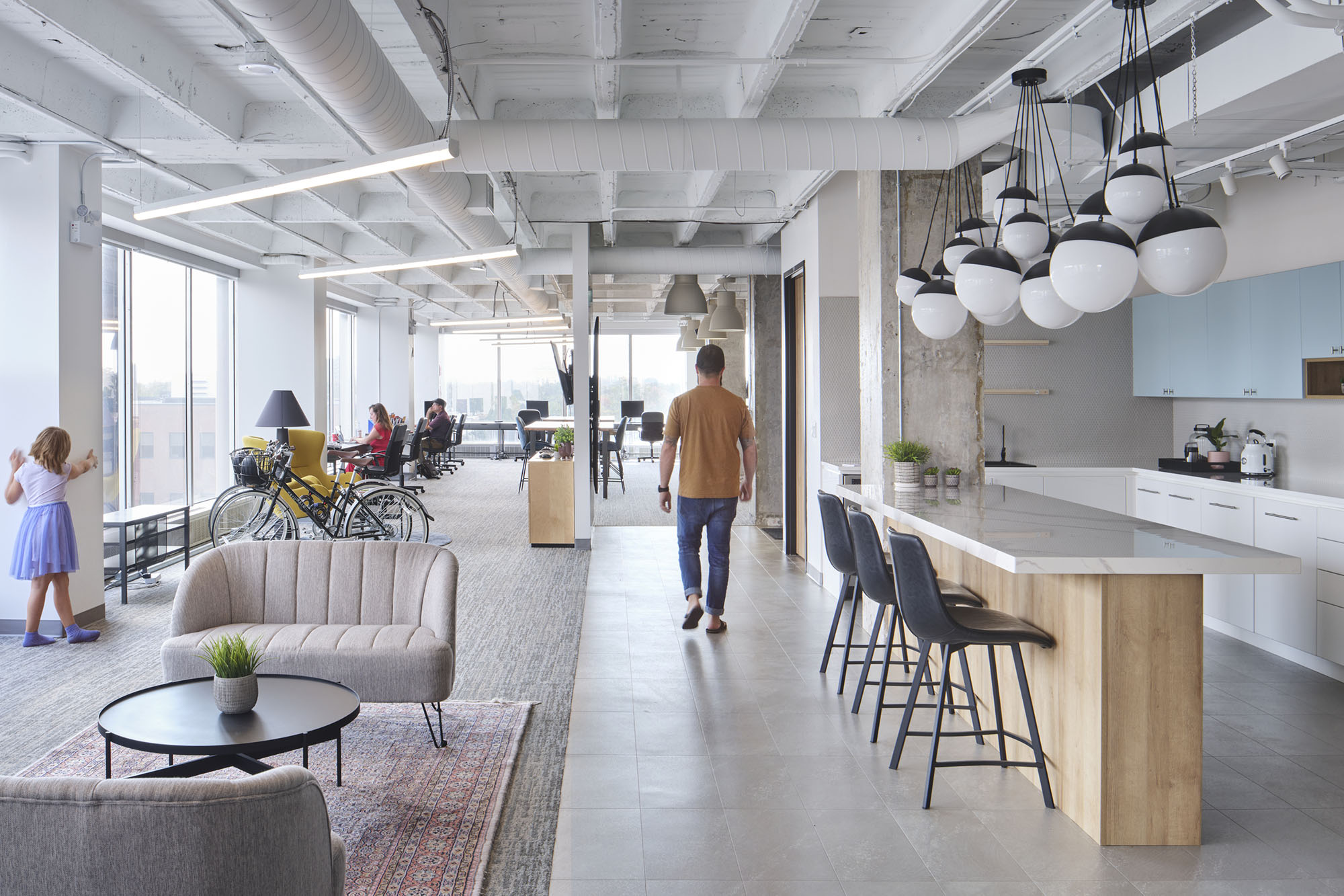 sunny open concept office with people working